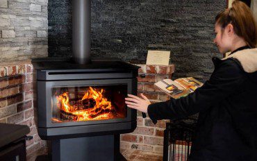 Woman looking to choose wood fire heater.